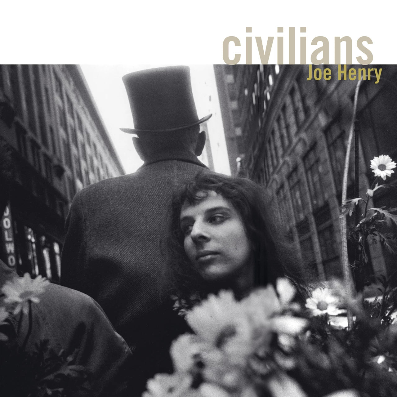 Black and white album cover with people and a flower.