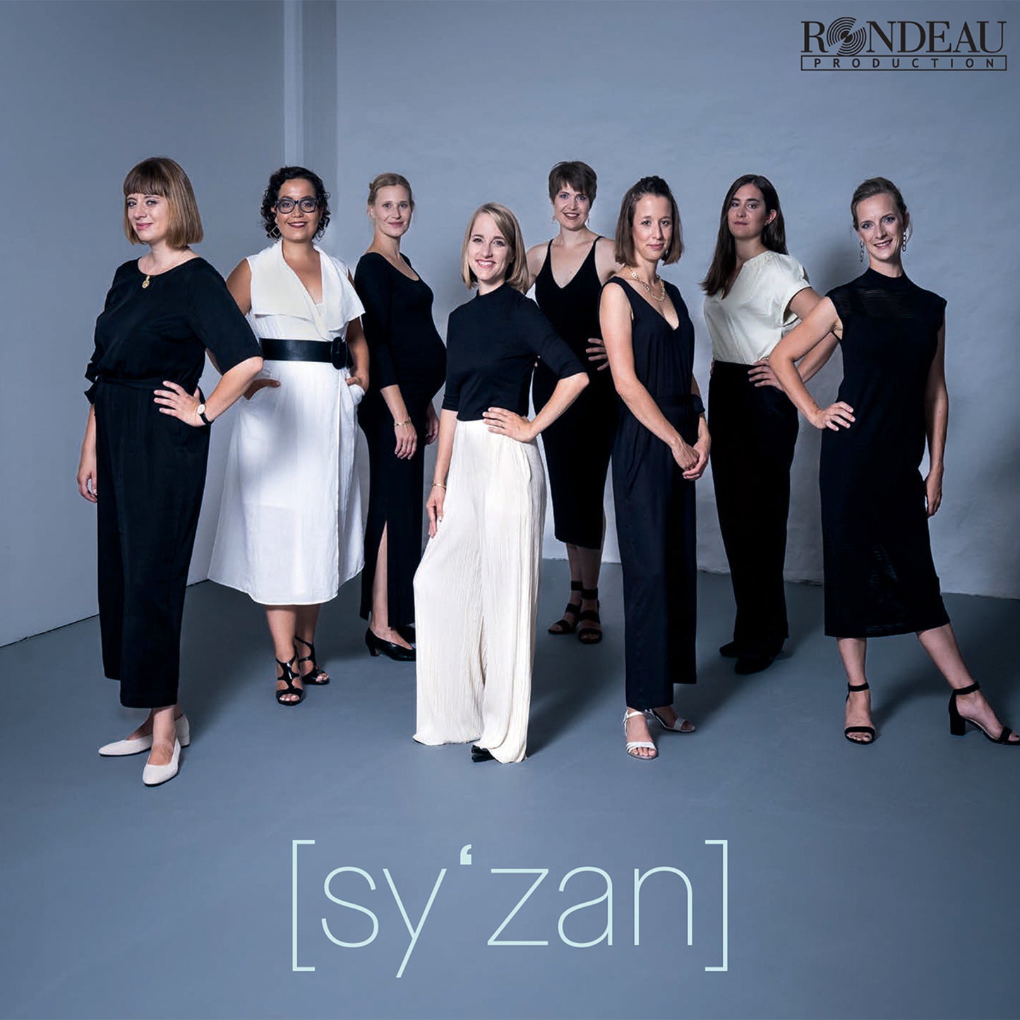 Nine women in dark clothing pose for a group portrait, CD cover.