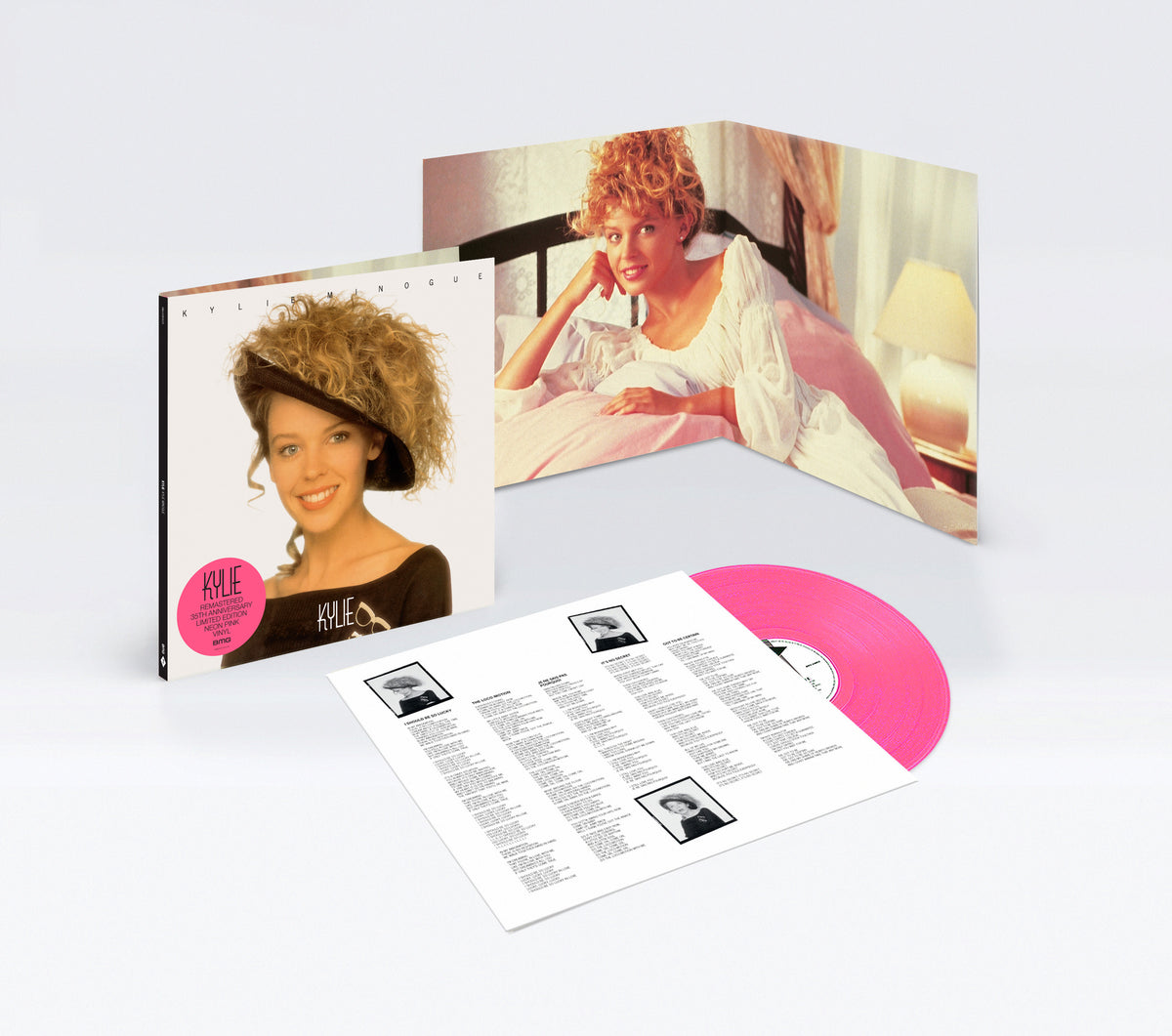 Kylie Minogue album cover, pink vinyl record, and lyric sheets laid flat.