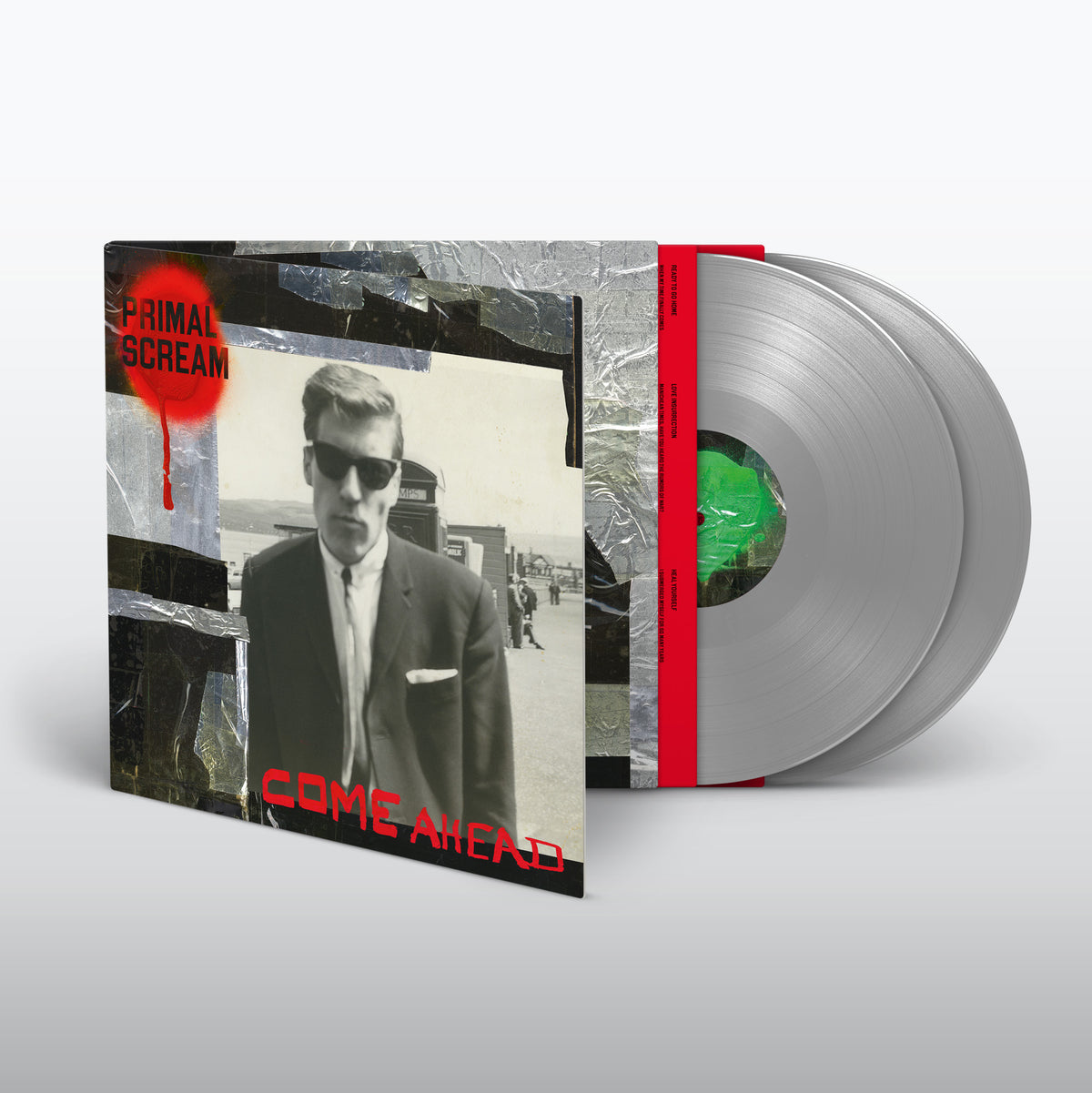Silver vinyl record with album cover featuring a man in a suit.