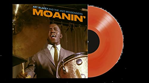 Art Blakey Moanin' album cover next to a solid red vinyl record.