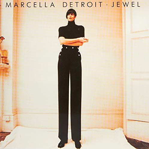 CD cover: woman in black outfit standing in a cream room.