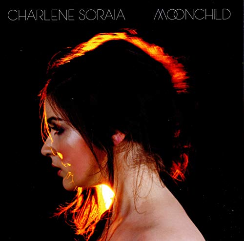 CD cover: woman’s profile with fiery orange hair against black background.