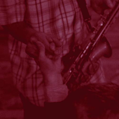 Close-up of hands playing a saxophone, red-toned and textured image.