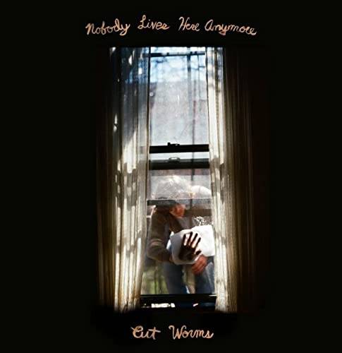 CD cover: person at window with hands pressed against glass.