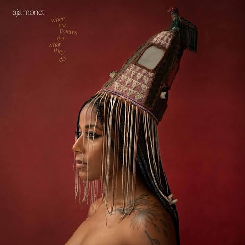Aja Monet album cover featuring a woman with ornate headwear.