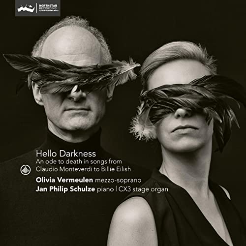 CD cover: two people with faces obscured by dark feathers.