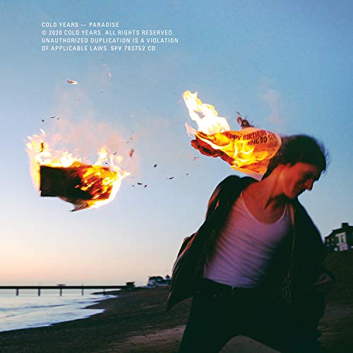 CD cover: man near burning newspaper with a beach background.