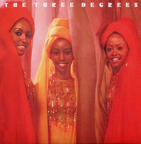 Album cover for The Three Degrees, featuring three women in colorful headwear.