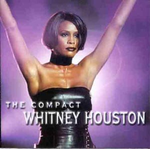 Whitney Houston album cover, portrait of singer with arms raised.