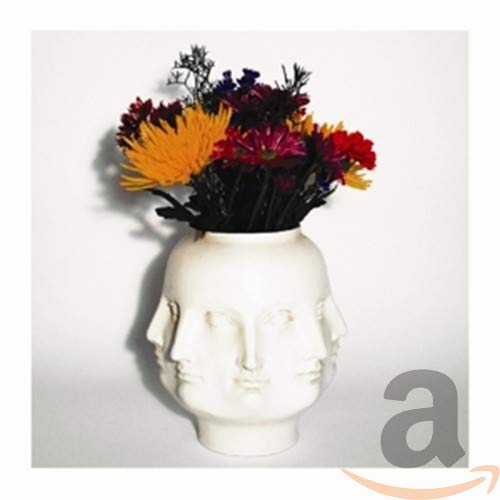 CD cover with a white vase shaped like multiple faces and flowers.