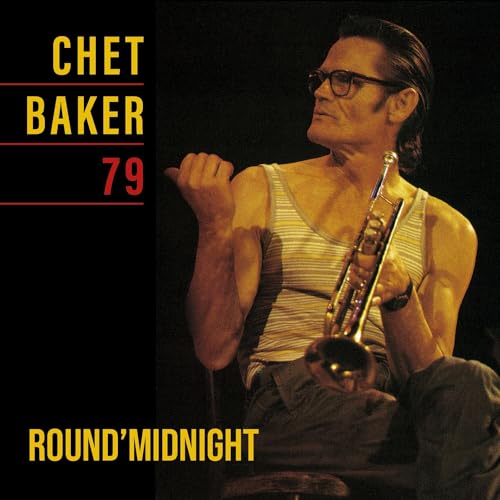 Chet Baker wearing glasses and a tank top, holding a trumpet on a dark background.