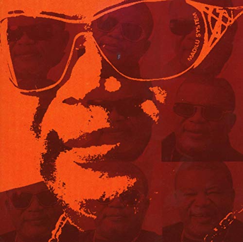 Red album cover featuring multiple portraits of a man wearing sunglasses.