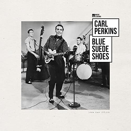 Black and white photo of Carl Perkins and band performing music.
