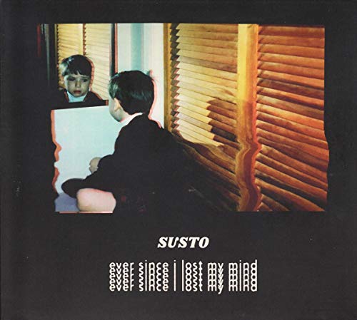 CD cover: boy viewed through distorted television screen, dark background.