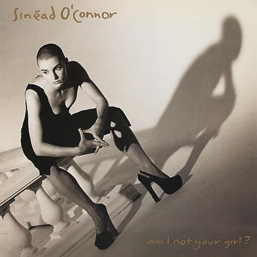 Sinead O'Connor album cover, black dress, striking pose, shadow detail.