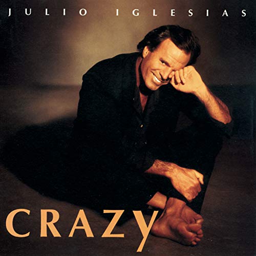 Julio Iglesias album cover, “Crazy”, featuring a smiling man in dark clothing.