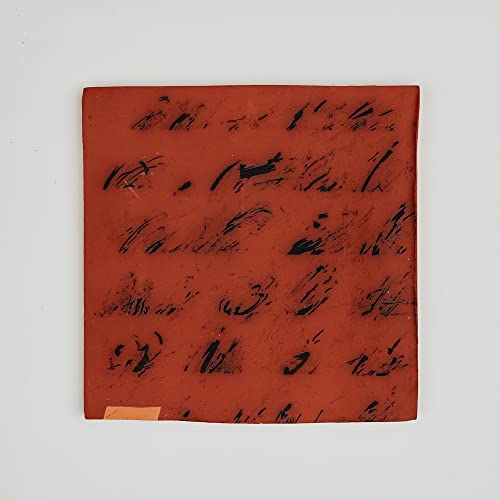 Red vinyl record sleeve with abstract black scribbles and a gold sticker.