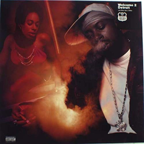 Vinyl record cover featuring J Dilla with a woman, smoky background.