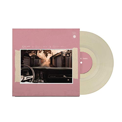 Pale yellow vinyl record with pink album cover featuring a street scene.
