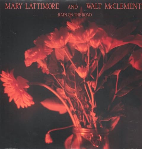 Album cover: red flowers in a glass jar against a dark background.