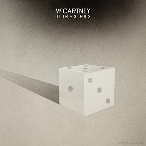 Album cover: a white die casting a shadow on a textured surface.