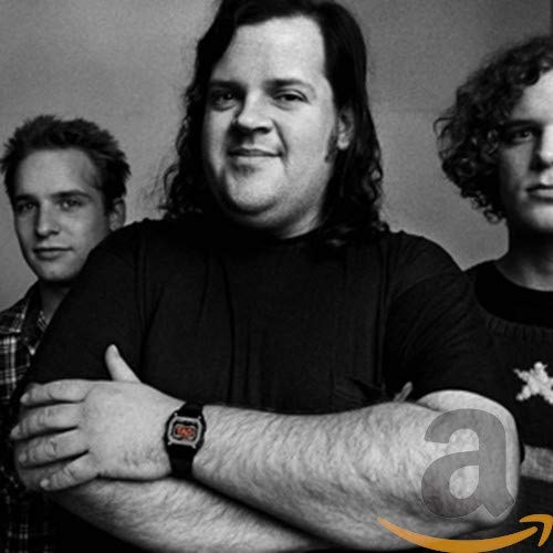 Black and white portrait of three men, a band called Tad.