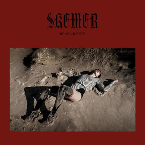 Album cover: person lying on a textured, sandy beach.