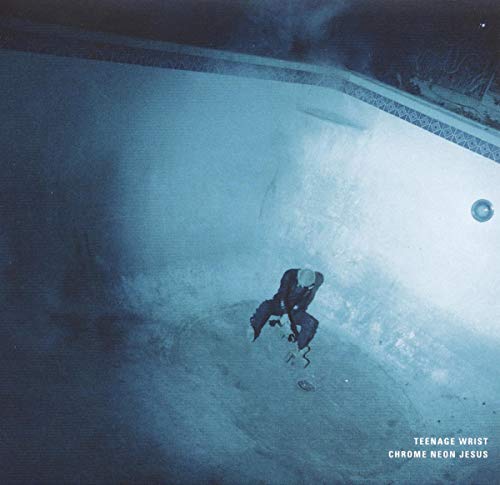 Skateboarder in an empty, blue-lit swimming pool, album cover.