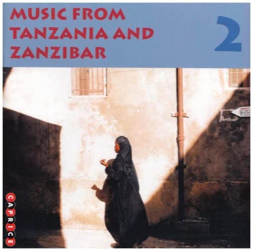 CD cover with a woman in a headscarf and building facade.