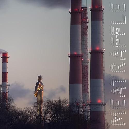 Industrial chimneys with a golden statue silhouetted against a cloudy sky.