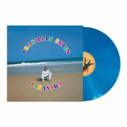 Blue vinyl record with album cover featuring a beach scene and text.