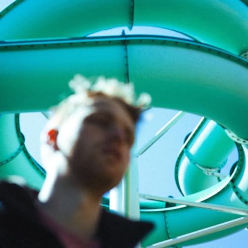 Person with white headphones viewed through a teal spiral structure.
