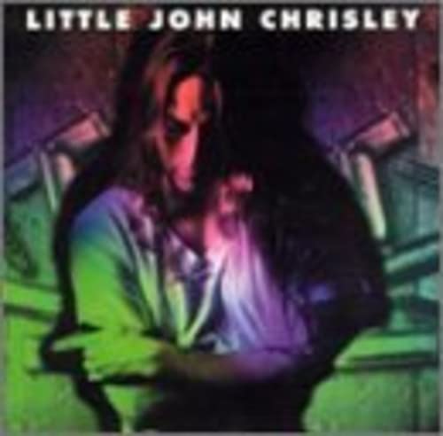 CD cover featuring a man with long hair in a dimly lit room.