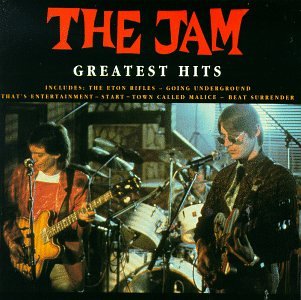 CD cover for The Jam’s “Greatest Hits” featuring band members performing.