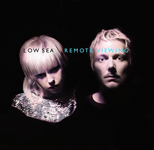 CD cover featuring two pale individuals with stylized hair, dark background.
