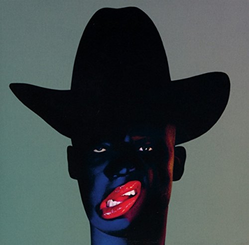 Dark-skinned face with red lips and a black cowboy hat.