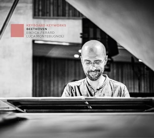 Black and white portrait of pianist Luca Montebugnoli at a grand piano.