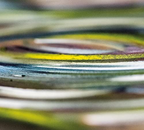 Close-up of a colorful, reflective CD surface with abstract patterns.