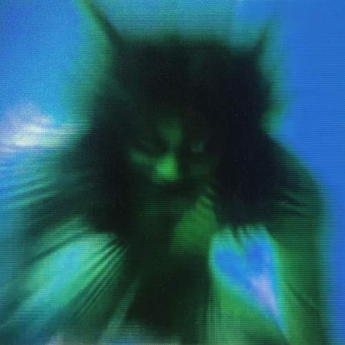 Blurred portrait of a person with long hair, teal and blue tones.