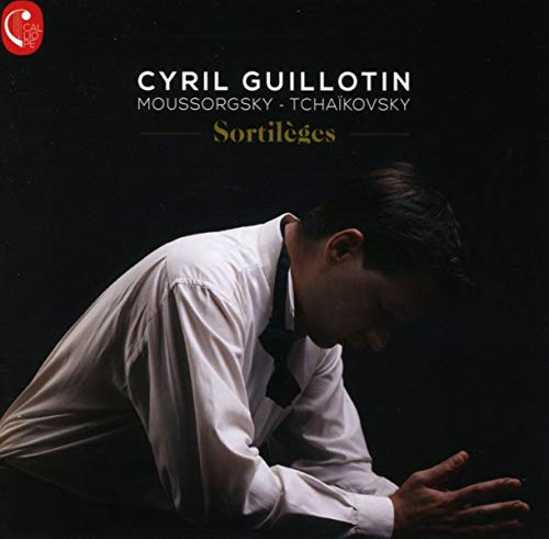 CD cover: portrait of a man in a white shirt, dark background.