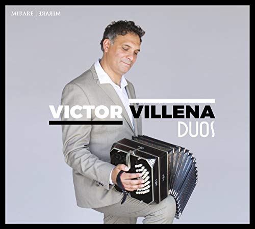 Man in a suit holding a black and silver accordion.