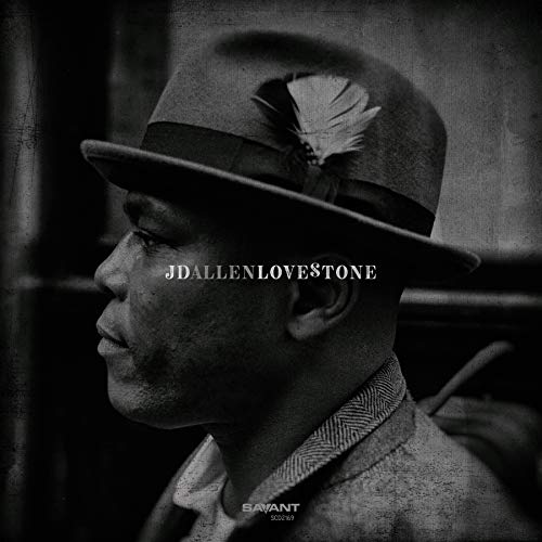 Black and white portrait of a man in a hat, album cover.