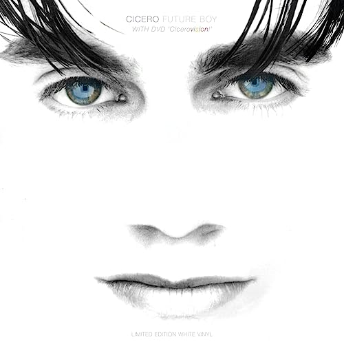 Close-up of a man’s face in grayscale, with striking blue eyes.