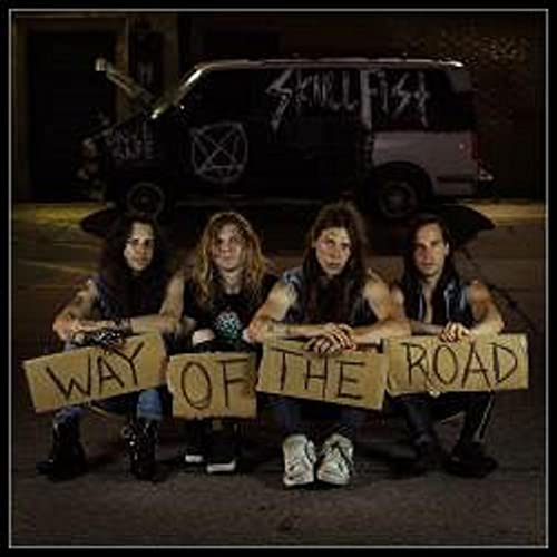 Band Skull Fist poses with cardboard signs in front of a van.