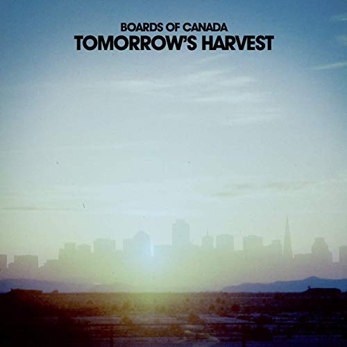 Album cover showing a hazy city skyline silhouette against a bright, pale blue sky.