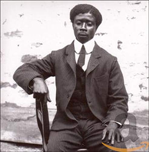 Vintage portrait of a Black man in a striped suit and tie.