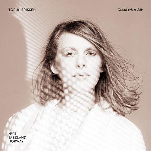 Vinyl album cover featuring a portrait of Torun Eriksen with light patterns.
