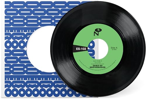Black vinyl record with a green and white center label, resting on sleeve.