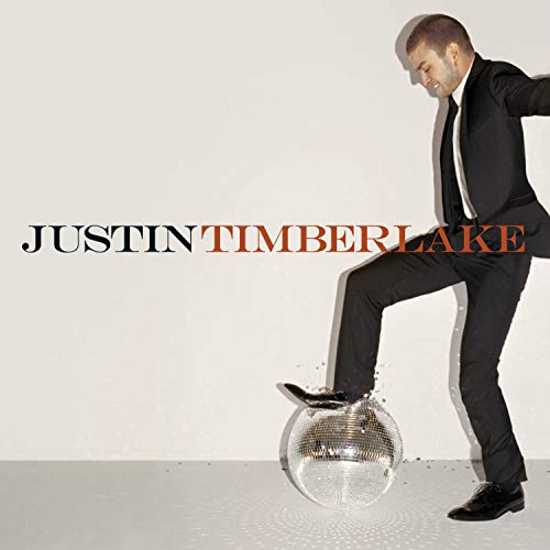 Justin Timberlake album cover, leaning on a disco ball, in a suit.